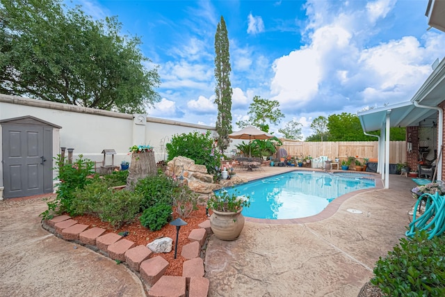 view of pool featuring a fenced backyard, a fenced in pool, and a patio area