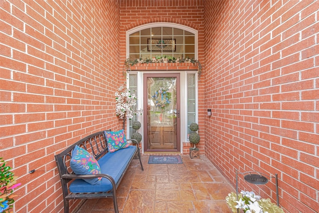 property entrance featuring brick siding