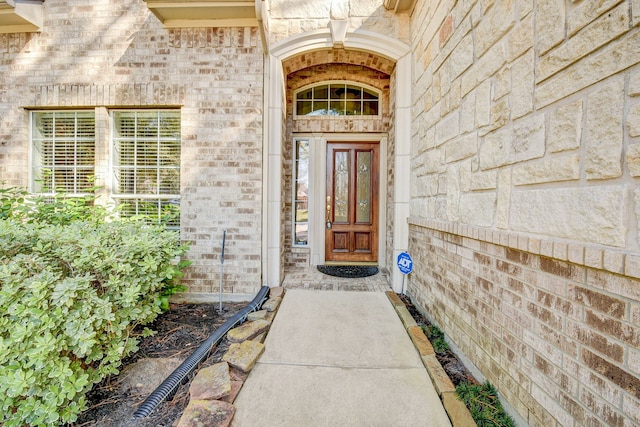 doorway to property with brick siding