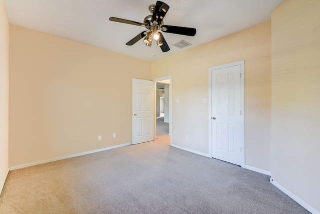 unfurnished bedroom featuring baseboards, visible vents, and carpet