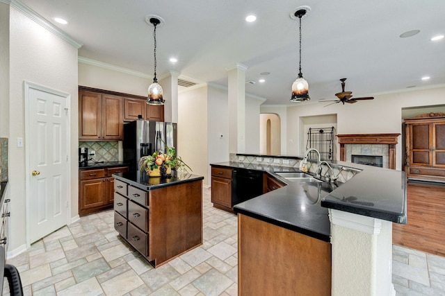 kitchen featuring dark countertops, a ceiling fan, dishwasher, stainless steel fridge with ice dispenser, and a kitchen island