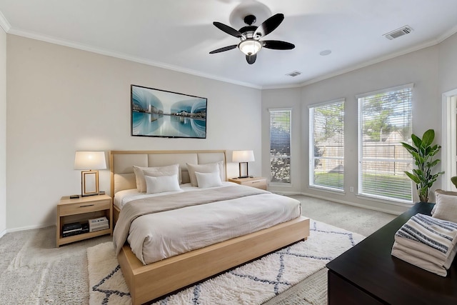 carpeted bedroom with baseboards, visible vents, ceiling fan, and crown molding