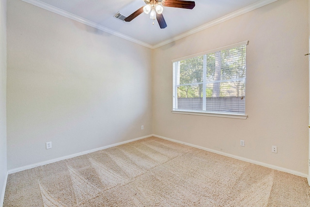 carpeted spare room featuring visible vents, a ceiling fan, baseboards, and ornamental molding