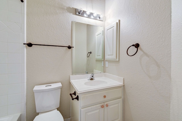 full bathroom with toilet and vanity