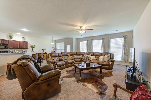 carpeted living room with plenty of natural light and ceiling fan
