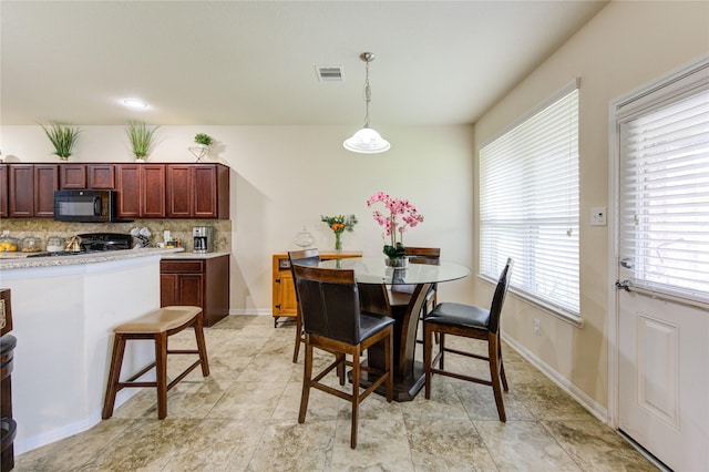 dining area with baseboards and visible vents