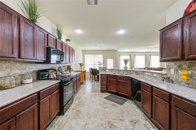 kitchen featuring black appliances, decorative backsplash, visible vents, and plenty of natural light