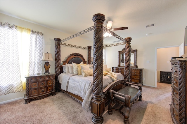 bedroom featuring light carpet, a ceiling fan, visible vents, and baseboards