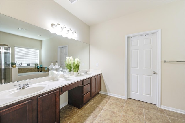 bathroom with a sink, double vanity, a stall shower, tile patterned flooring, and a garden tub