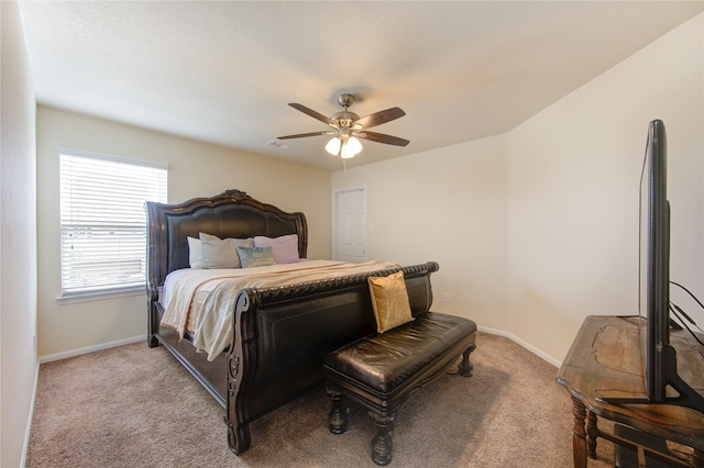 bedroom with light carpet, a ceiling fan, and baseboards