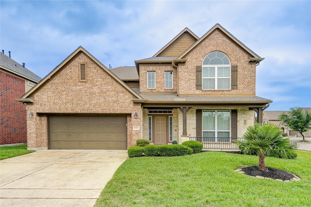 traditional-style home featuring driveway, a shingled roof, covered porch, a front yard, and brick siding