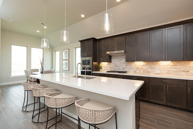 kitchen with dark wood-style floors, a sink, and tasteful backsplash
