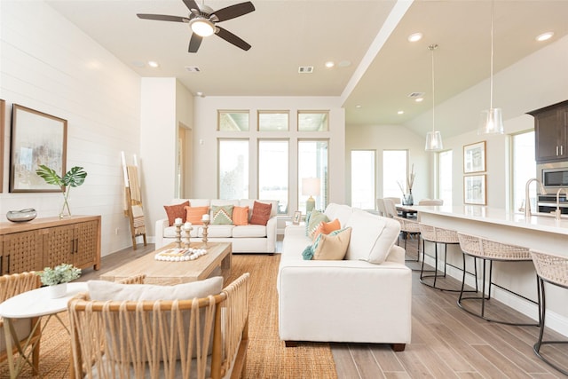 living area featuring recessed lighting, light wood-style flooring, visible vents, and a ceiling fan