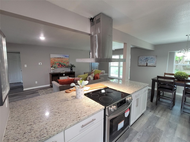 10654 Mayfield Rd, Houston, TX 77043 - kitchen featuring island exhaust hood, stainless steel electric range, light stone counters, and wood finished floors