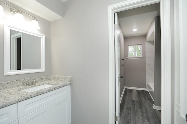10654 Mayfield Rd, Houston, TX 77043 - bathroom with baseboards, vanity, and wood finished floors