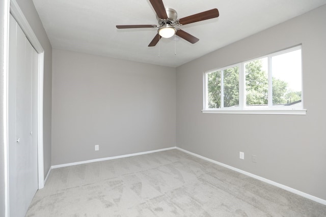 10654 Mayfield Rd, Houston, TX 77043 - unfurnished bedroom featuring ceiling fan, light carpet, a closet, and baseboards