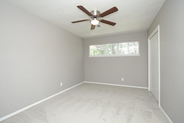 10654 Mayfield Rd, Houston, TX 77043 - unfurnished bedroom featuring baseboards, a ceiling fan, and light colored carpet