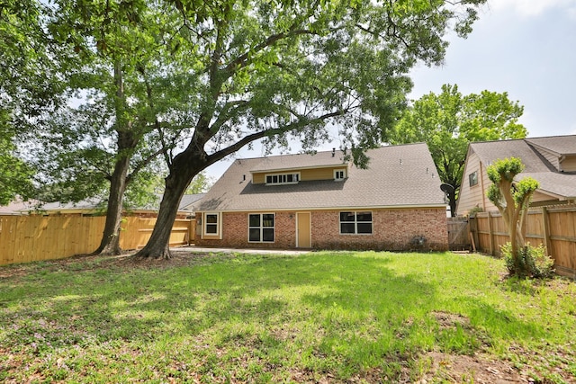 10654 Mayfield Rd, Houston, TX 77043 - back of house with a lawn, a fenced backyard, and brick siding