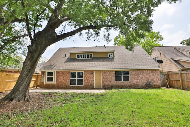10654 Mayfield Rd, Houston, TX 77043 - rear view of property featuring a patio area, a shingled roof, a fenced backyard, a yard, and brick siding