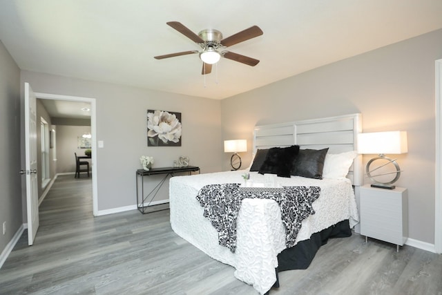 10654 Mayfield Rd, Houston, TX 77043 - bedroom with baseboards, a ceiling fan, and wood finished floors