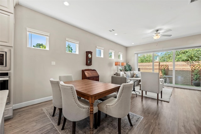 dining space featuring a ceiling fan, visible vents, baseboards, recessed lighting, and light wood-style flooring