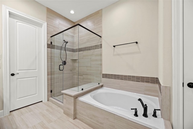 bathroom featuring a garden tub and a stall shower