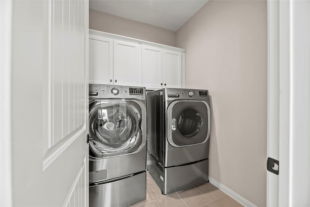 3105 Magnolia Knoll Ln, Houston, TX 77080 - washroom featuring cabinet space, baseboards, washing machine and dryer, and light tile patterned floors
