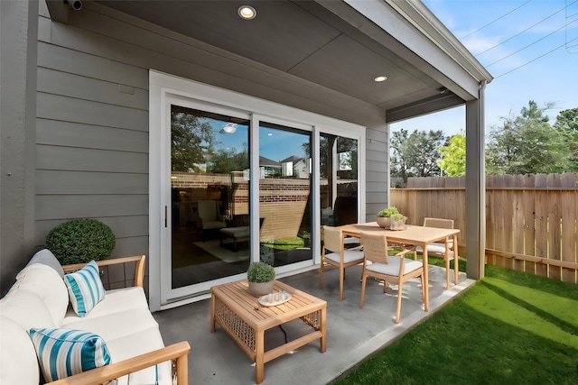 view of patio with fence, outdoor lounge area, and outdoor dining space