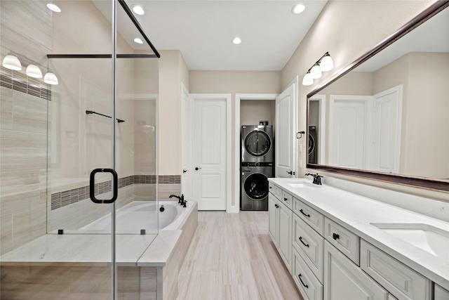 3105 Magnolia Knoll Ln, Houston, TX 77080 - bathroom with double vanity, stacked washer / dryer, recessed lighting, a sink, and a stall shower