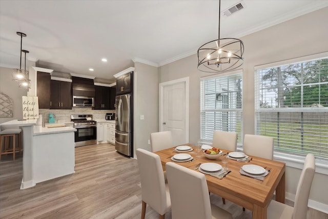 dining area with light wood-style flooring, visible vents, an inviting chandelier, recessed lighting, and ornamental molding