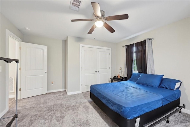 carpeted bedroom with visible vents, a ceiling fan, baseboards, and a closet
