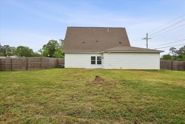 back of property featuring a fenced backyard, cooling unit, and a lawn
