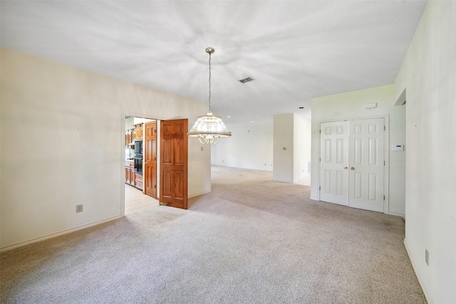 12 Cherry Hill Dr, Conroe, TX 77304 - empty room with a chandelier, light colored carpet, and baseboards