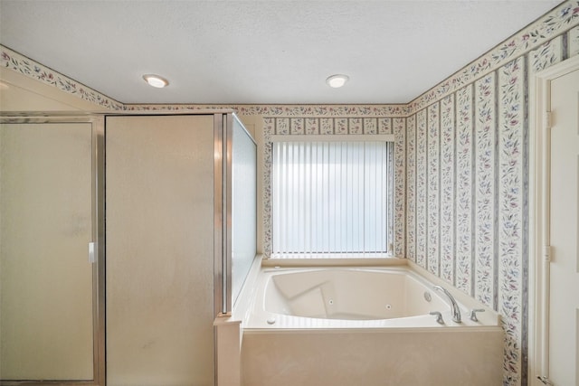12 Cherry Hill Dr, Conroe, TX 77304 - bathroom featuring wallpapered walls, a shower stall, a whirlpool tub, and a textured ceiling