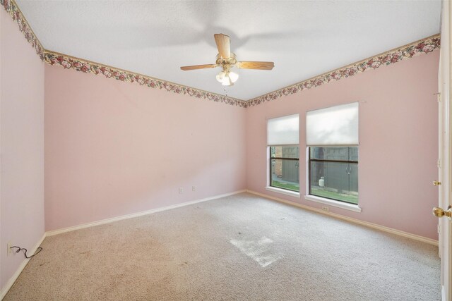 12 Cherry Hill Dr, Conroe, TX 77304 - carpeted empty room with baseboards and ceiling fan
