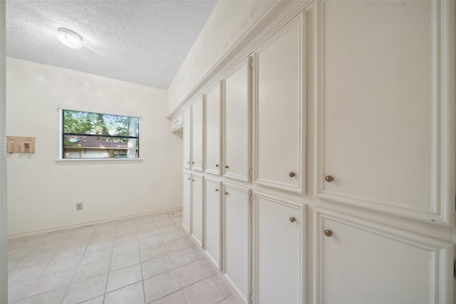12 Cherry Hill Dr, Conroe, TX 77304 - hall featuring a textured ceiling and light tile patterned floors