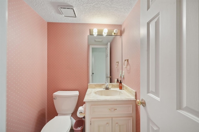 12 Cherry Hill Dr, Conroe, TX 77304 - bathroom with a textured ceiling, toilet, and vanity