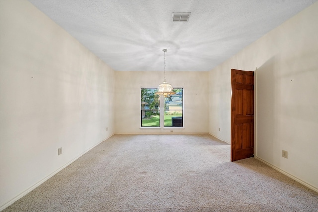 12 Cherry Hill Dr, Conroe, TX 77304 - carpeted empty room with baseboards, a chandelier, and a textured ceiling
