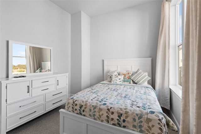 bedroom featuring dark colored carpet
