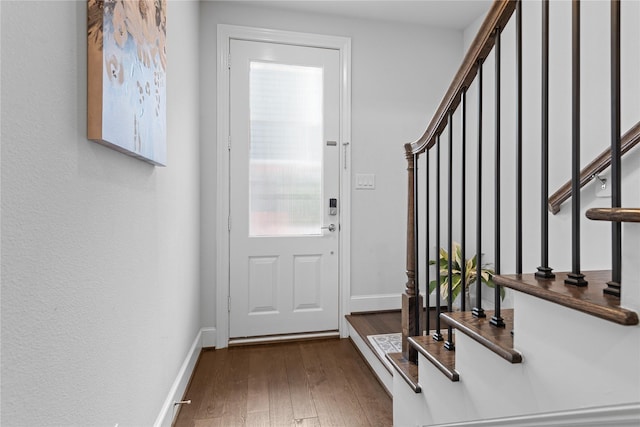 doorway to outside with stairway, baseboards, and wood finished floors