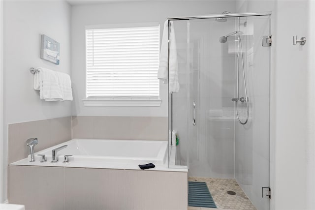 full bathroom with a bath and a stall shower