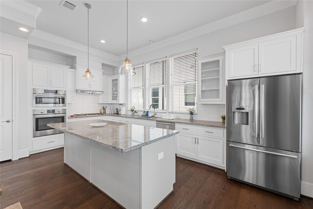 kitchen featuring white cabinets, appliances with stainless steel finishes, visible vents, and glass insert cabinets