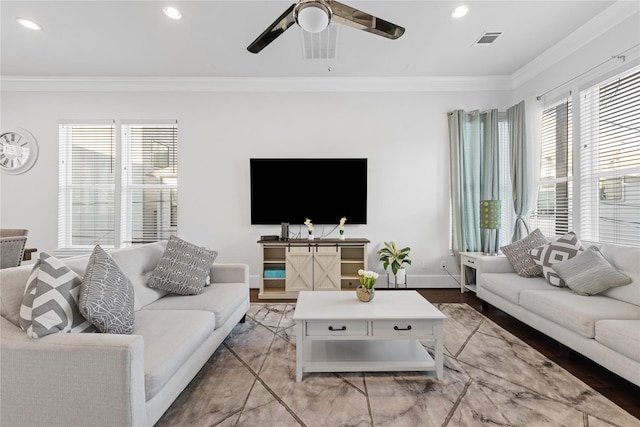 living room featuring recessed lighting, a wealth of natural light, and ornamental molding