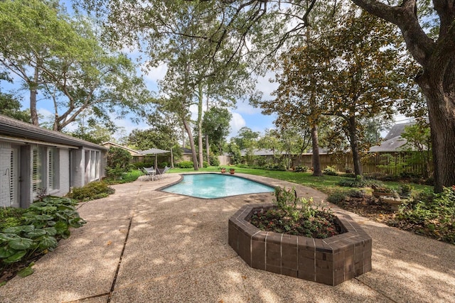 view of pool featuring a patio, a fenced backyard, and a fenced in pool