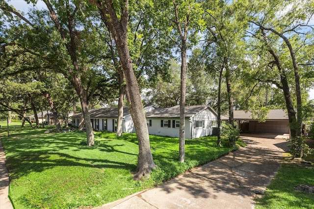 ranch-style home with a front lawn, driveway, and an attached carport