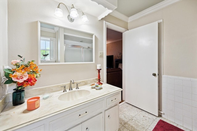 full bathroom with vanity, crown molding, and a stall shower