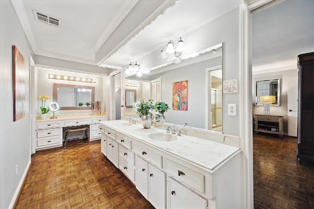 bathroom featuring visible vents, ornamental molding, and a sink