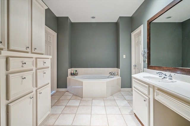 full bathroom with a bath, baseboards, vanity, and tile patterned floors