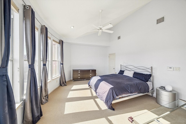 bedroom with vaulted ceiling, visible vents, ceiling fan, and light carpet