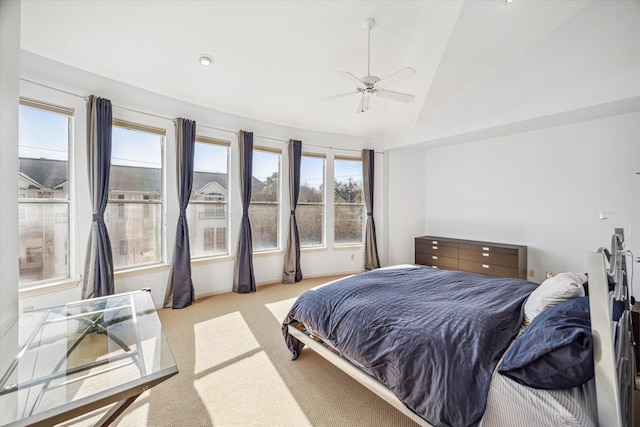 bedroom featuring ceiling fan, vaulted ceiling, and carpet flooring